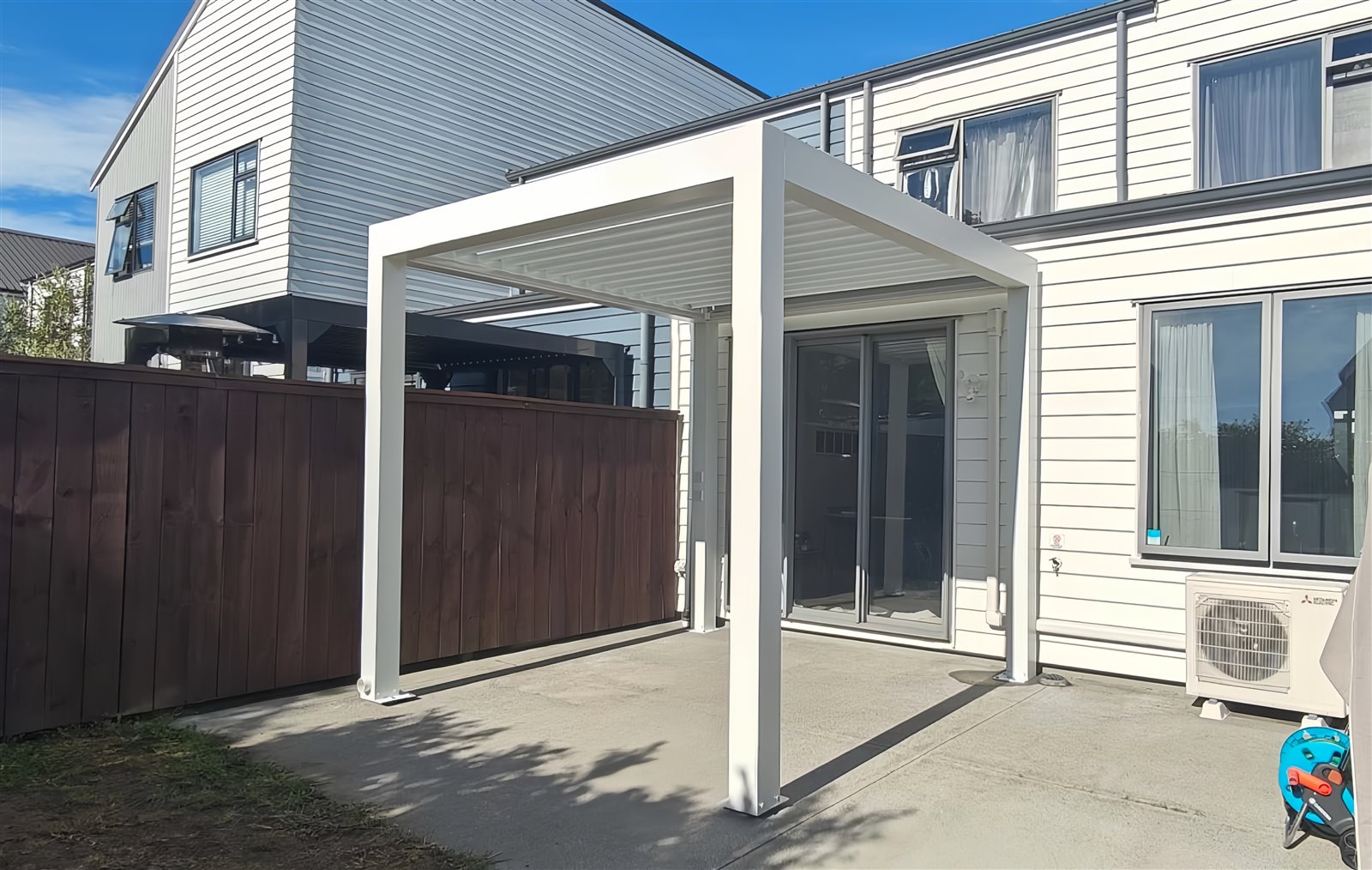 White 3 by 3 metre louvered pergola on a compact residential patio