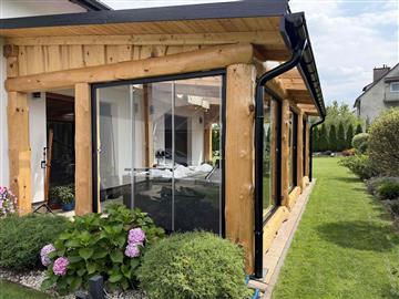 Exterior corner view of a glazed residential sunroom in Poland