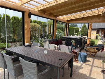 Dining and seating area inside a glazed garden sunroom