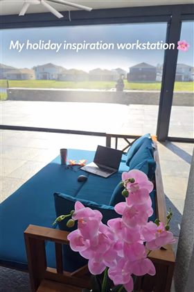 Covered patio beneath the fixed-roof pergola used as a customer workstation