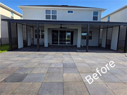 Patio before the fixed-roof aluminum pergola and side screens were completed